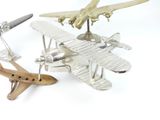 two toy airplanes sitting next to each other on a white surface