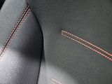 a close up of a car seat with a red stitching on it