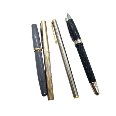 three different types of pens are lined up on a white surface