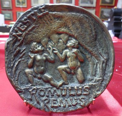 a close up of a coin on a table with a red cloth