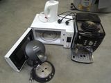 a microwave and a coffee maker sitting on the floor