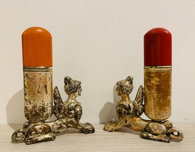 two candles that are sitting next to each other on a table