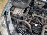the engine of a car with its hood open on the side of the road