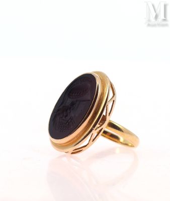 an image of a gold ring with a black stone in the center