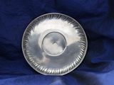 a silver plate that is sitting on a blue cloth