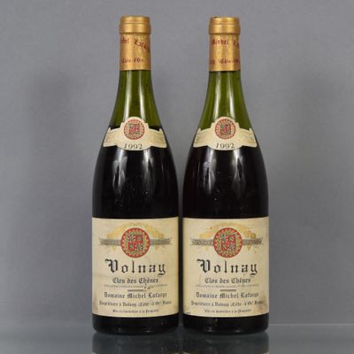 two bottles of wine sitting on top of a table next to each other