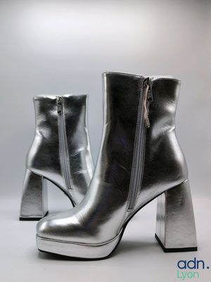 silver leather ankle boots with zippers on a white background