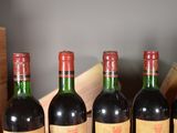 several bottles of wine are lined up in a row on a table