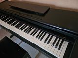 a piano that is sitting on the floor next to a chair