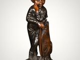 an image of a statue of a boy with a hat and cane