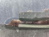 a reflection of a person in the rear window of a car