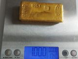 a gold bar on top of a scale on a table