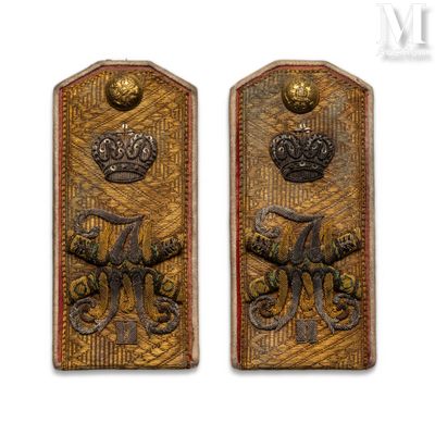 two metal plaques with a crown and a crown on them