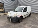 la petite camionnette blanche est garée devant un bâtiment