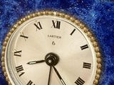 a blue clock with roman numerals on it