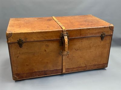 an old wooden trunk sitting on top of a white table