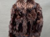 the mannequin is wearing a brown fur coat and jeans