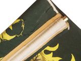 a close up of a green and yellow bag with a zipper
