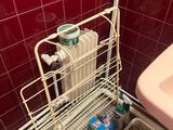 a sink and a toilet in a bathroom with red tiles