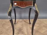 a small table with a drawer on top of it on a wooden floor