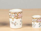 four cups and a container on a table