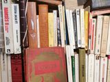 many books that are on a wooden table