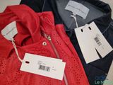 two pairs of red and blue jackets with tags on them