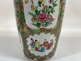 a vase with a bird on it sitting on a table
