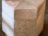 a small white box with a gold base on a table