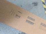 a cardboard box with a barcode on it sitting on the floor