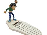 figurine of a man on a surfboard with a gun in his hand