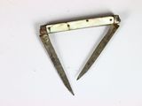 an old pair of scissors on a white surface