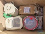 a cardboard box filled with assorted containers and containers