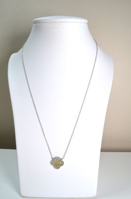 silver necklace with a yellow flower pendant on a white mannequin