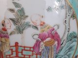 a blue vase with a painting on it sitting on a table