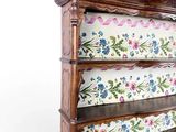 a wooden shelf with a floral design on it