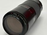 a black camera lens sitting on a white surface