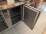 a stainless steel counter top with an open door