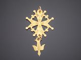 a gold cross pendant on a black background
