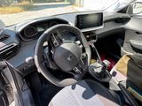 a steering wheel and dashboard of a car in a parking lot
