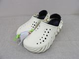 a pair of shoes that are on a bed