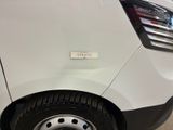 the rear end of a white van with a sticker on it ' s bumper
