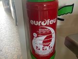 a red fire extinguisor attached to a wall