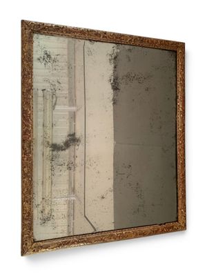a picture of a mirror hanging on the wall