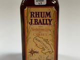 an old bottle of rum is sitting on a white surface