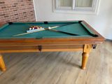 a pool table with a pool cue and a pool ball on it