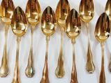a lot of spoons that are lined up on the table