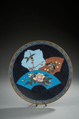an image of a blue and black plate with flowers and birds on it