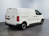 the back of a white van parked in a large room