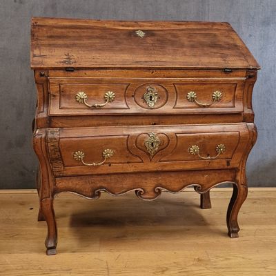 an old wooden chest of drawers on a wooden floor